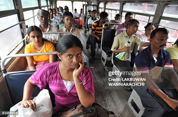 Sri Lankan passengers aboard a bus wait for its departure in Maharagama suburb of Colombo on June 7, 2008. Sri Lankans are living on the edge as a...