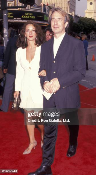 Actor Alan Rickman and date attending the premiere of "Robin Hood-Prince of Thieves" on June 10, 1991 at Mann Village Theater in Westwood, California.