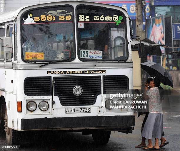 Sri Lankan passengers board a bus in Maharagama suburb of Colombo on June 7, 2008. Sri Lankans are living on the edge as a wave of bomb attacks,...