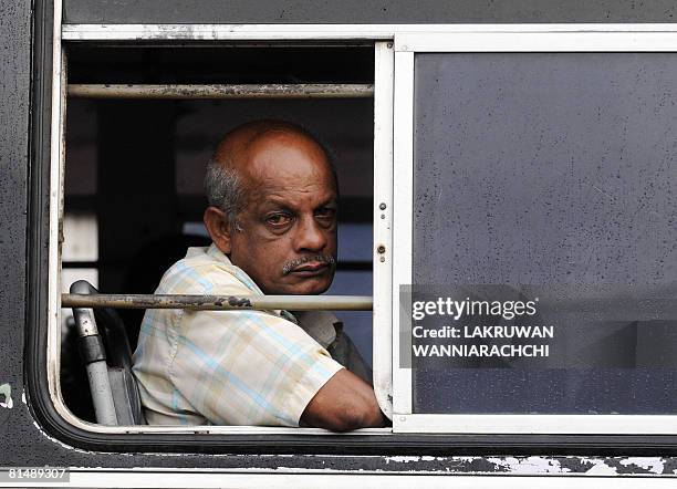 Sri Lankan passenger aboard a bus waits for its departure in Maharagama suburb of Colombo on June 7, 2008. Sri Lankans are living on the edge as a...