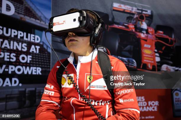 Young man uses a virtual reality headset at the fan zone during qualifying for the Formula One Grand Prix of Great Britain at Silverstone on July 15,...
