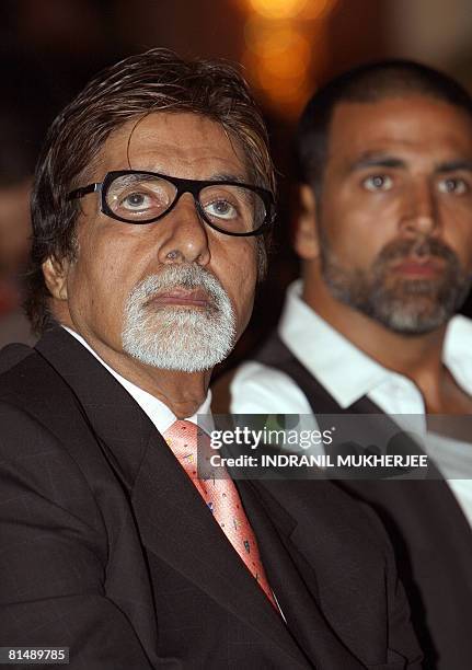 Indian actors Amitabh Bachchan and Akshay Kumar watch a presentation at a press conference on the third and final day of the International Indian...