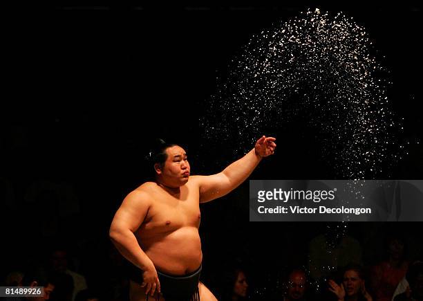 Asashoryu tosses a handful of salt into the dohyo to purify the dohyo prior to his match during the 2008 Grand Sumo Tournament at the Los Angeles...