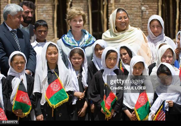 First Lady Laura Bush poses with local children whlie visiting the future site for the Ayenda Learning Center in the Bamiyan Province, Afghanistan,...