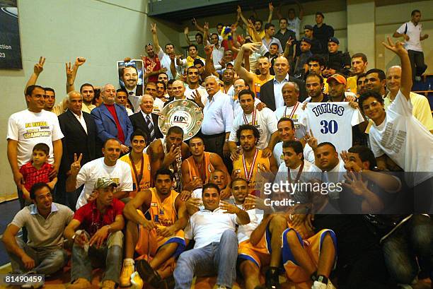 Players and supporters of Lebanon's Al-Riyadi Sporting Beirut basketball team celebrate their fourth consecutive FLB championship win after beating...