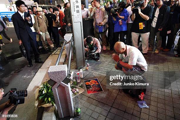 Man prays at a cross road where seven people were stabbed to death and 10 people were injured in a rampage at Tokyo's electric quarter Akihabara on...