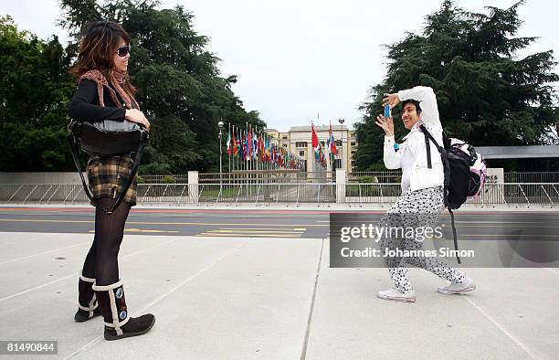 Two Taiwanese tourists pose in front of the United Nations Office on June 8, 2008 in Geneva, Switzerland. Housed at the Palais des Nations, the...