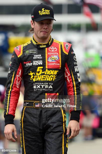 Erik Jones, driver of the 5-hour ENERGY Extra Strength Toyota, stands in the garage area during practice for the Monster Energy NASCAR Cup Series...