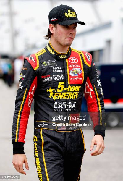 Erik Jones, driver of the 5-hour ENERGY Extra Strength Toyota, walks through the garage area during practice for the Monster Energy NASCAR Cup Series...