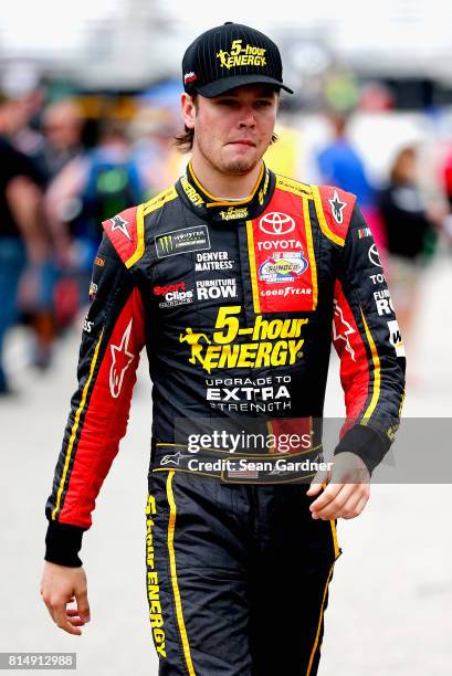 Erik Jones, driver of the 5-hour ENERGY Extra Strength Toyota, walks through the garage area during practice for the Monster Energy NASCAR Cup Series...