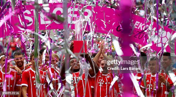 Franck Evina of Muenchen celebrates with the trophy after winning the Telekom Cup 2017 Final between SV Werder Bremen and FC Bayern Muenchen at...