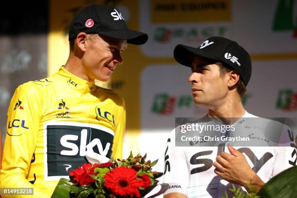Christopher Froome of Great Britain riding for Team Sky in the leader's jersey and Mikel Landa of Spain riding for Team Sky talk on stage during...