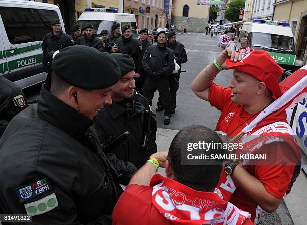 German riot police talk with Polish football fans celebratring in a street of Klagenfurt on June 8 a few hours before the beginning of the Euro 2008...