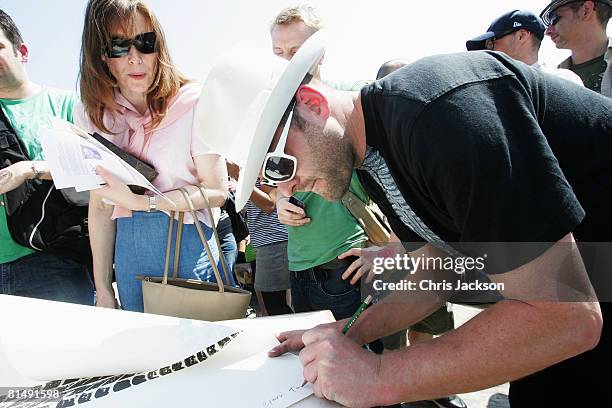 Artist Gavin Turk signs copies of his ?200 per metre 'Tyre Tread' Prints during the Vauxhall Art Car Boot fair in the Old Truman Brewery on June 8,...