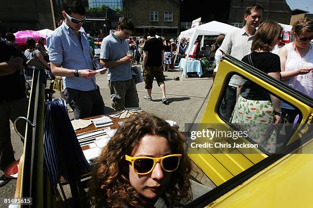 Stall holders sell their wares from the backs of their cars during the Vauxhall Art Car Boot fair in the Old Truman Brewery on June 8, 2008 in...