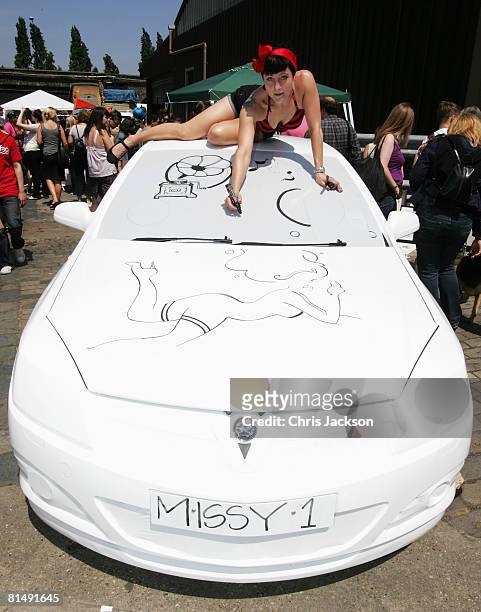 Illustrater and Aritist 'Miss Led' works on her artwork on the body of a Vauxhall car during the vauxhall Art Car Boot fair in the Old Truman Brewery...