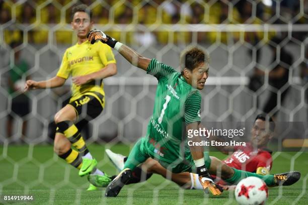 Emre Mor of Burussia Dortmund scores his side's first goal past goalkeeper Shusaku Nishikawa of Urawa Red Diamonds during the preseason friendly...