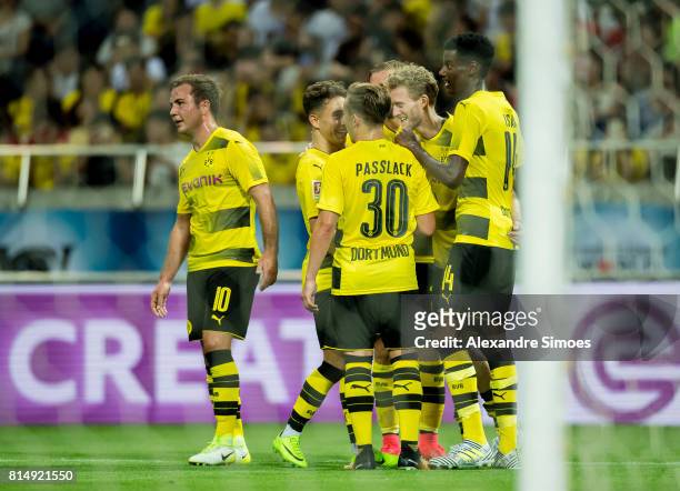 Andre Schuerrle of Borussia Dortmund celebrates after his winning goal to 3-2 with his teammates during the preseason friendly match between Urawa...