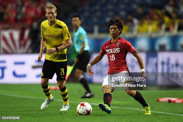 Yoshiaki Komai of Urawa Red Diamonds in action during the preseason friendly match between Urawa Red Diamonds and Borussia Dortmund at Saitama...