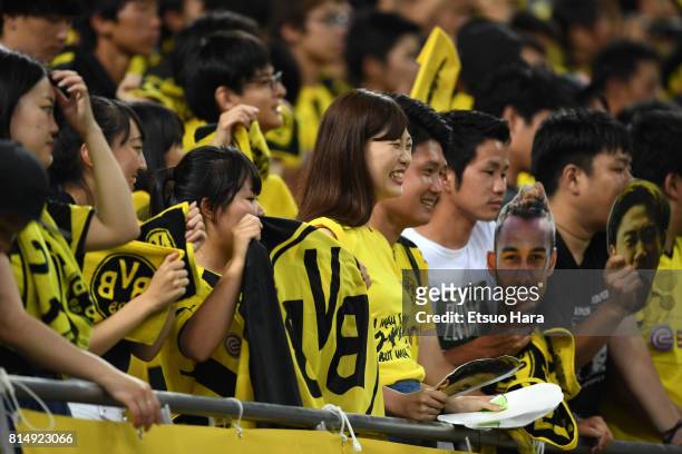 Japanese fans of Burussia Dortmund cheer after the preseason friendly match between Urawa Red Diamonds and Borussia Dortmund at Saitama Stadium on...