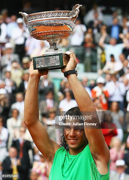 Rafael Nadal of Spain lifts the trophy following his victory during the Men's Singles Final match against Roger Federer of Switzerland on day fifteen...