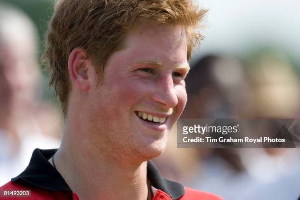 Prince Harry unshaven and flushed and after playing polo on a hot day at Cirencester Park Polo Club in the Umbogo team in a charity polo match...