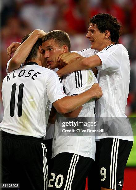 Lukas Podolski of Germany is celebrated by his team mates Mario Gomez and Miroslav Klose after scoring the opening goal during the UEFA EURO 2008...