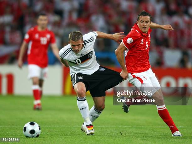 Lukas Podolski of Germany runs past Dariusz Dudka of Poland during the UEFA EURO 2008 Group B match between Germany and Poland at Worthersee Stadion...
