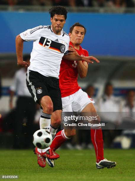 Michael Ballack of Germany challenges Dariusz Dudka of Poland during the UEFA EURO 2008 Group B match between Germany and Poland at Worthersee...