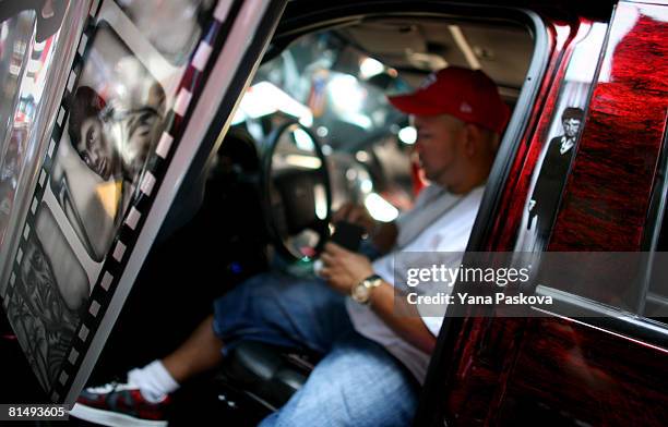 Nelson Bonilla sits inside his car decorated with the likeness of Tony Montana of the movie "Scarface" at the annual Puerto Rico Day Parade June 8,...