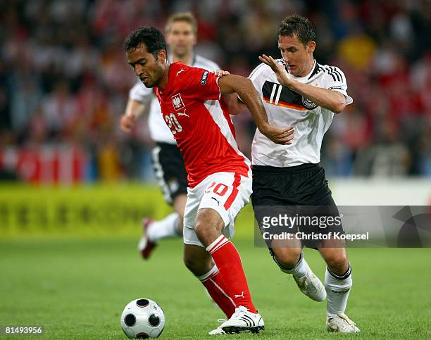 Roger Guerreiro of Poland is shut down by Miroslav Klose of Germany during the UEFA EURO 2008 Group B match between Germany and Poland at Worthersee...