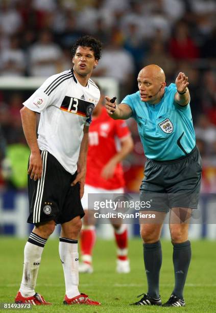 Michael Ballack of Germany grimaces as referee Tom Henning Ovrebo awards a free kick during the UEFA EURO 2008 Group B match between Germany and...