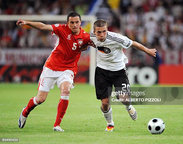 Polish midfielder Dariusz Dudka vies with German forward Lukas Podolski during their Euro 2008 Championships Group B football match Germany vs....