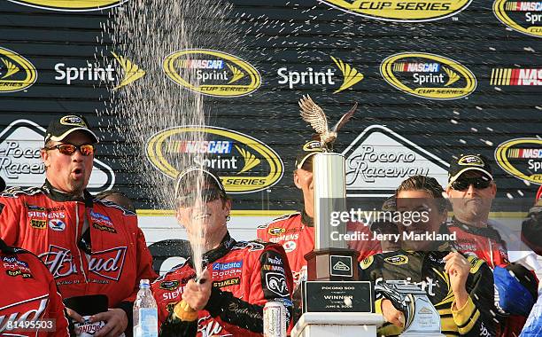 Kasey Kahne sprays champagne in celebration of winning the NASCAR Sprint Cup Series Pocono 500 on June 8, 2008 at Pocono International Raceway in...