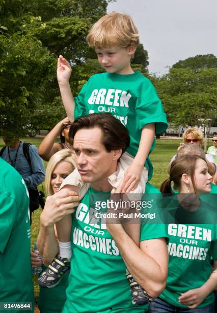 Evan Asher and Jim Carrey march toward the U.S. Capitol Building at the Green Our Vaccines rally on June 4, 2008 in Washington, DC.