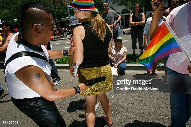 Woman gets a consensual good-natured spanking from a marcher in the 38th annual LA Pride Parade June 8, 2008 in West Hollywood, California....