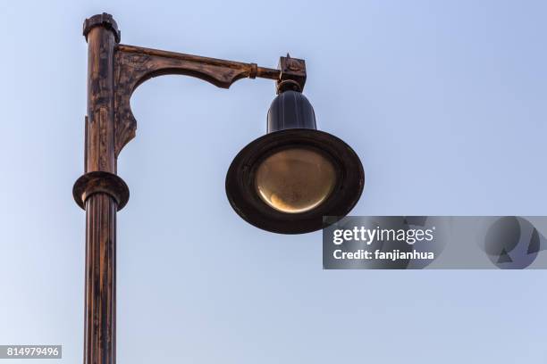 detail shot of antique street lamp against sky - antique lightbulb stockfoto's en -beelden