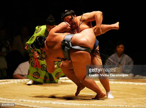 Asasekiryu takes down Tokitenku with a leg kick or "ashitori" in the third round during the 2008 Grand Sumo Tournament at the Los Angeles Memorial...