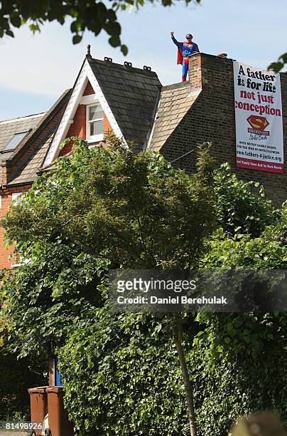 Fathers for Justice' campaigner stands atop Deputy Labour Leader Harriet Harman's home on June 9, 2008 in south London. The protest focuses on...