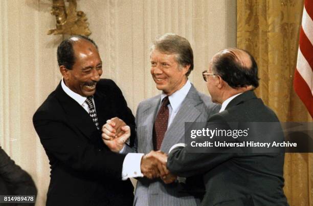 Egyptian President Anwar Sadat, United states President Jimmy Carter and Israeli Prime Minister Meacham Begin, celebrate after signing the Camp David...