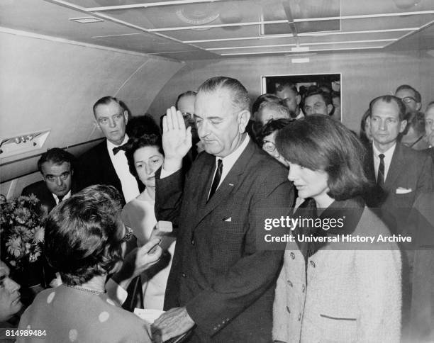 Vice President Lyndon Johnson, sworn in as President following the assassination of John F Kennedy November 22 1963. He is watched by Jacquie Kennedy...