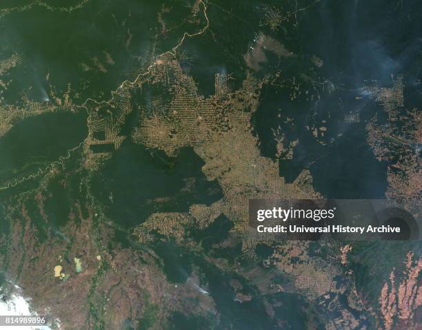 Deforestation of the Amazon rainforest at Rondonia, Brazil. In this image, intact forest is deep green, while cleared areas are tan or light green ....