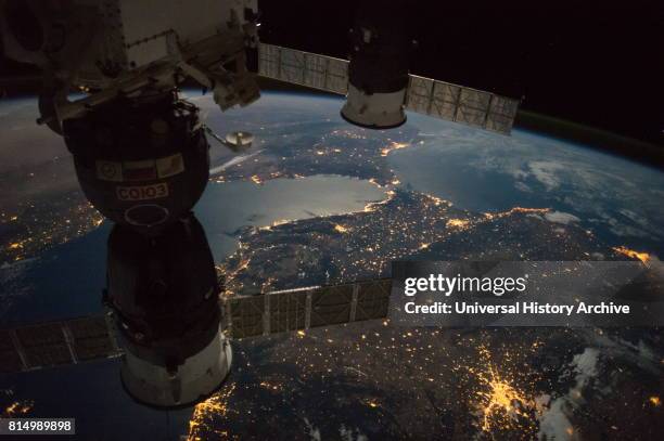 View of the Strait of Gibraltar with a Russian Soyuz spacecraft and Progress spacecraft in the foreground 2016.