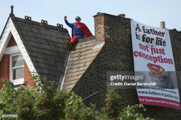 Fathers for Justice' campaigner stands atop Deputy Labour Leader Harriet Harman's home on June 9, 2008 in south London. The protest focuses on...