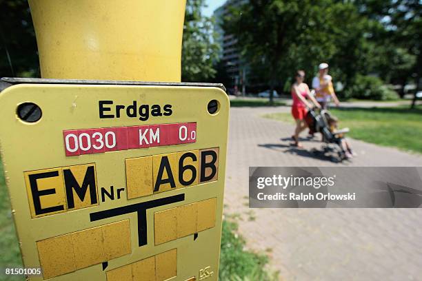 Pedestrians walk along a sign that refers to a gas line on June 9, 2008 in Frankfurt, Germany. The German Department of Environment expects a rise of...