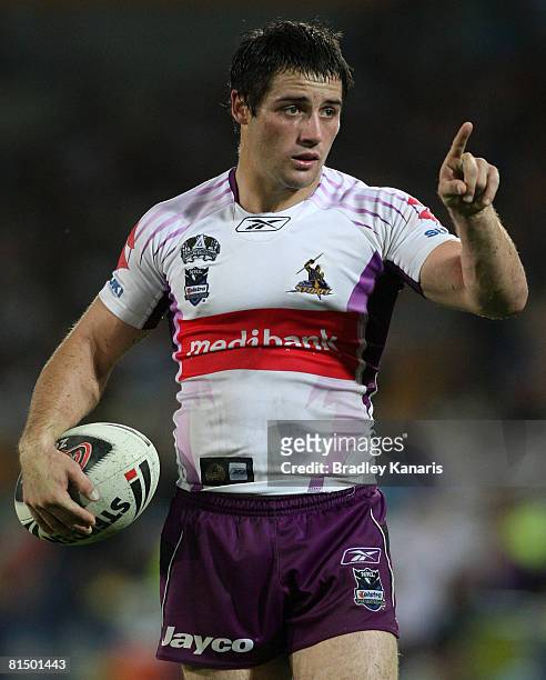 Cooper Cronk of the Storm points to his players as he gives out instructions during the round 13 NRL match between the Gold Coast Titans and the...