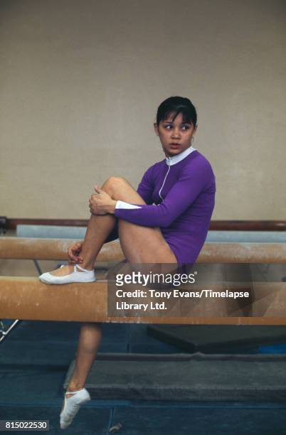 Soviet gymnast and Olympic gold medalist Nellie Kim poses on a balance beam, 1976.