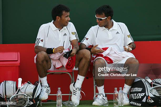 Sanchai Ratiwatana of Thailand and Sonchat Ratiwatana of Thailand talk during their match against Eric Butorac of USA and Rajeev Ram of USA on Day 1...