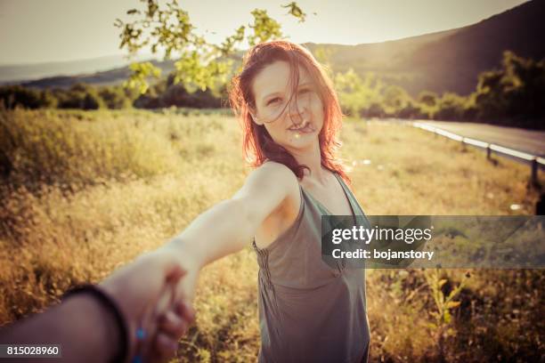 follow me-young woman holding man hand - head mount display stock pictures, royalty-free photos & images