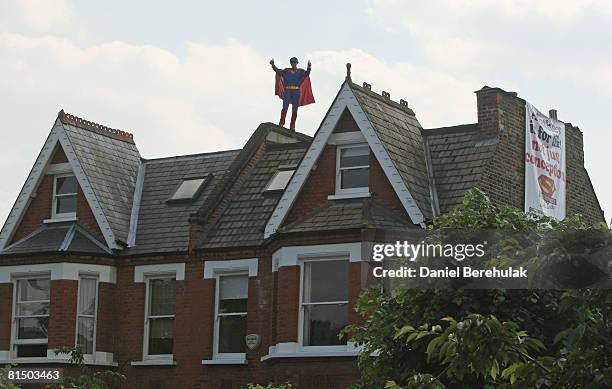 Fathers For Justice' campaigner dressed as Superman gives the thumbs up gesture as he stands on the roof of Deputy Labour Leader Harriet Harman's...